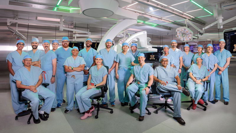 A team of vascular surgeons pose for a photo in an operating room at MedStar Health.