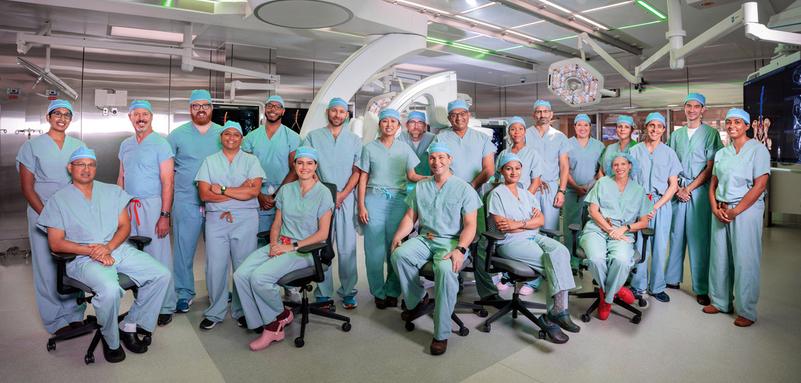 A team of vascular surgeons pose for a photo in an operating room at MedStar Health.