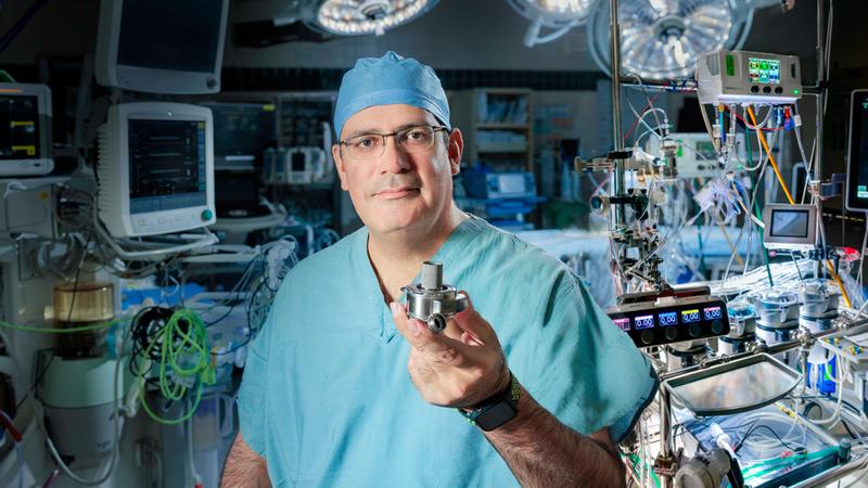 Dr Keki Balsara holds an LVAD device.