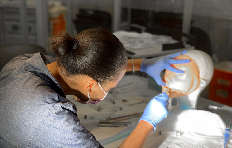 A simulation student practices in a simulation lab.