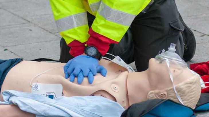 A healthcare professional executes chest compressions on a simulation mannequin during a training exercise at MedStar Health.