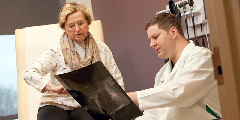 Dr Matthew Wallace talks with a patient during an office visit at MedStar Health.