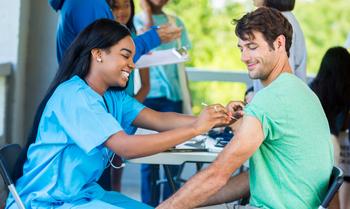 Man receives immunization from at vaccination clinic