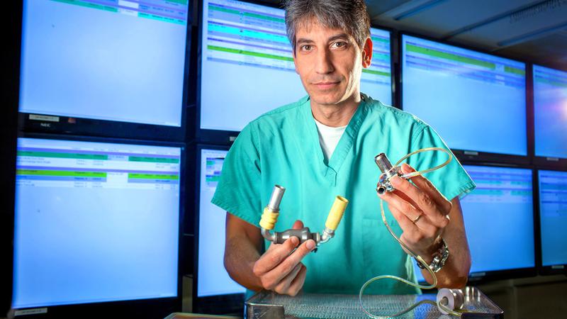 Dr Samer Najjar holds an LVAD device in the cardiac catheterization lab at MedStar Health.
