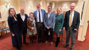 John Valanos and family and representatives from MedStar Health pose for a group photo