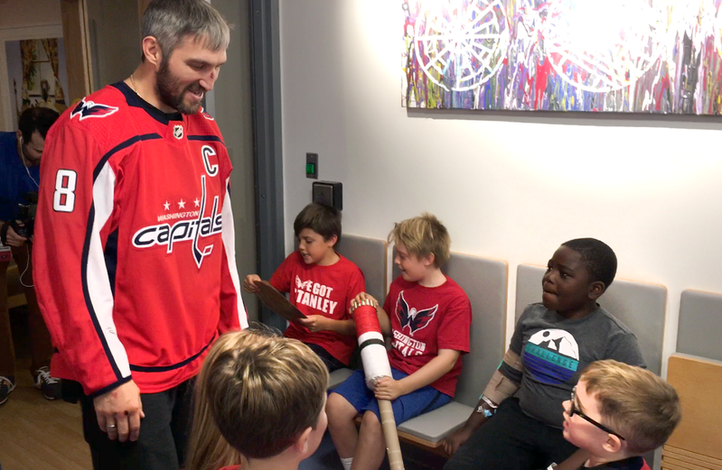 Washington Capitals Alex Ovechkin visits a group of children in a hospital.