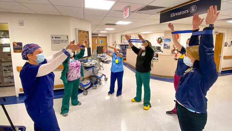 Healthcare professionals at MedStar Georgetown University Hospital take a few minutes to do exercises to promote wellbeing.