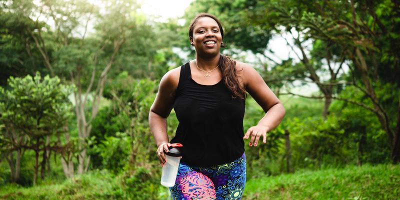 A woman body positive exercising in nature.