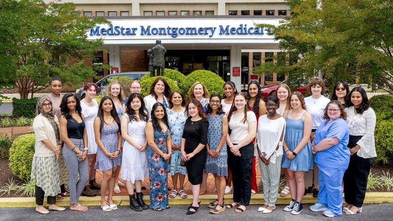 Group photo of MedStar Montgomery Medical Center Women's Board Scholarship winners in front of the hospital building.