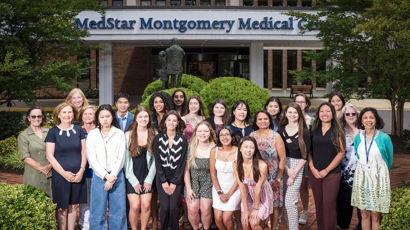 Group photo of MedStar Montgomery Medical Center Women's Board Scholarship winners in front of the hospital building.