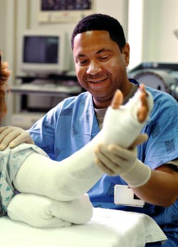 A MedStar Health wound care physician applies a bandage to a patient's arm.
