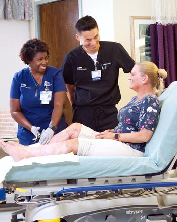 A MedStar Health wound care physician applies a bandage to a patient's arm.