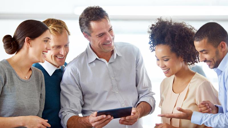 Shot of a group of colleagues using a digital tablet together